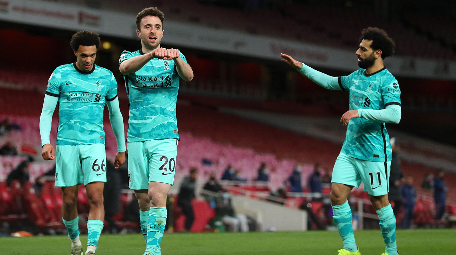 Liverpool's Portuguese striker Diogo Jota (2nd L) celebrates scoring his team's second goal during the English Premier League football match between Arsenal and Liverpool at the Emirates Stadium in London on April 3, 2021.
