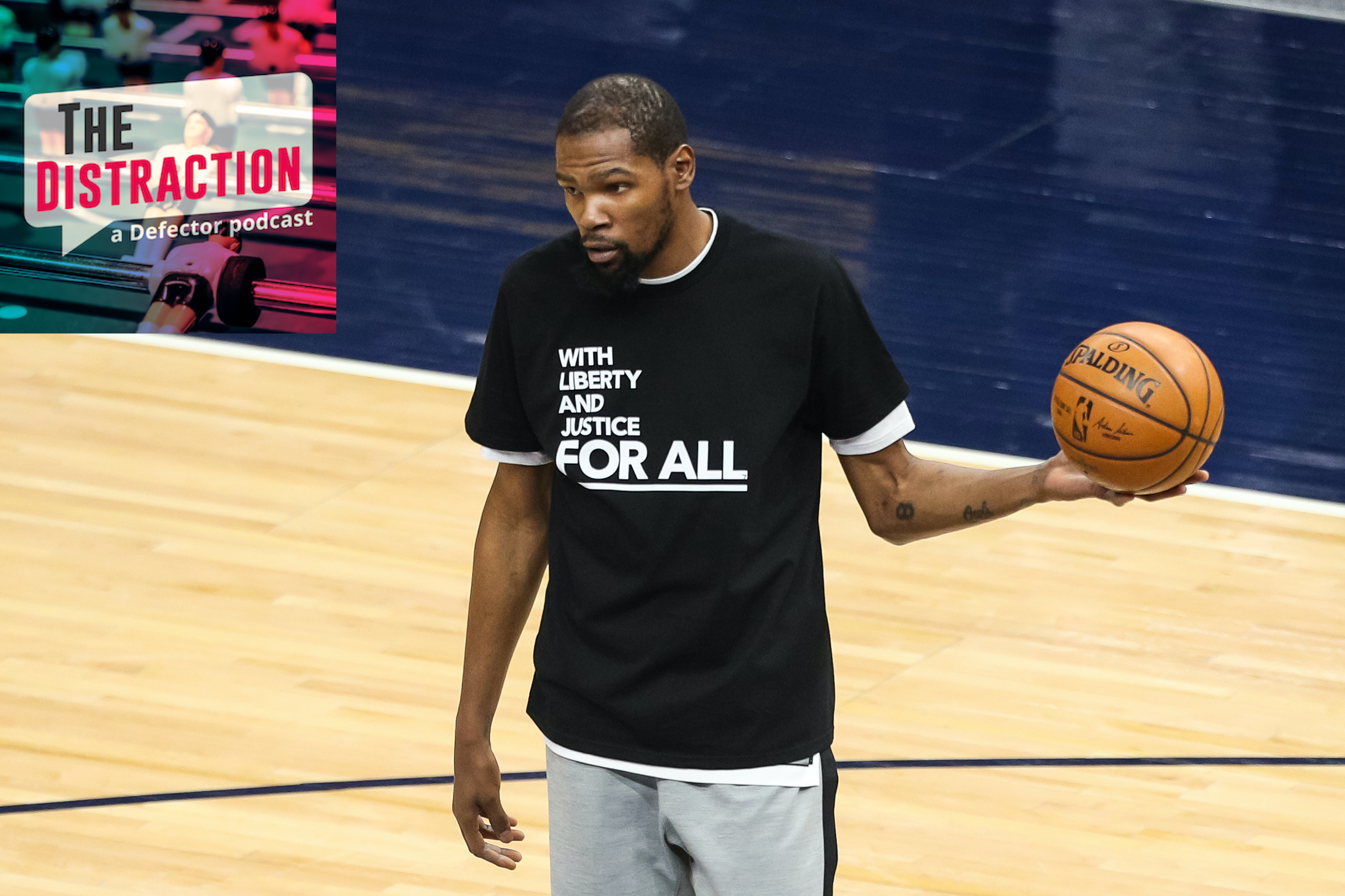 Kevin Durant warms up before Tuesday's game against the Timberwolves in a meaningful t-shirt.