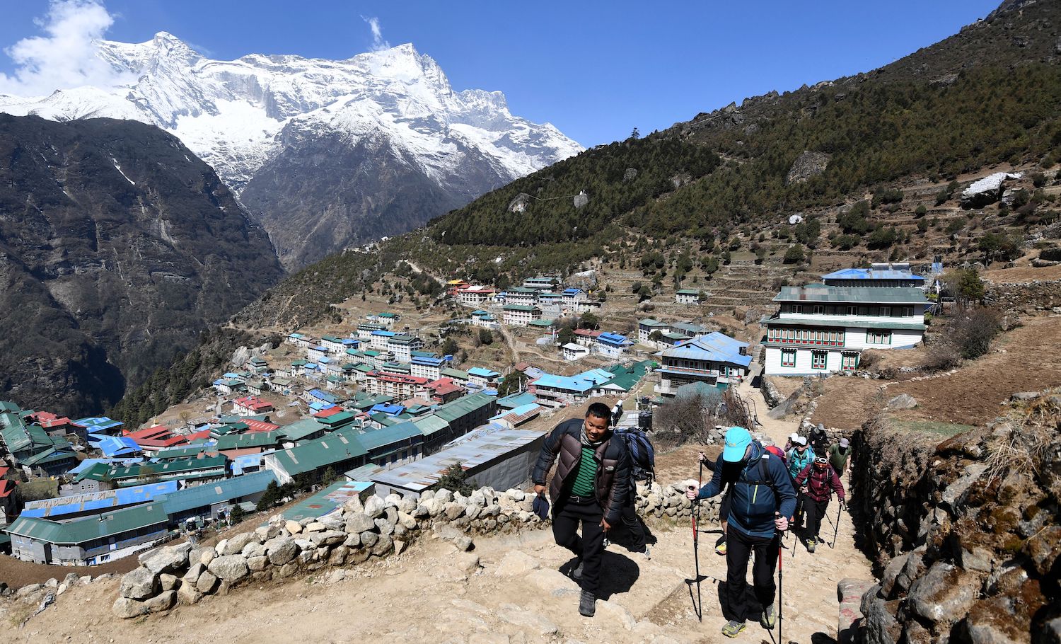 Trekkers walk along a path at Namche Bazar town in the Everest region of Solukhumbu district on April 25, 2021. (Photo by PRAKASH MATHEMA / AFP) (Photo by PRAKASH MATHEMA/AFP via Getty Images)