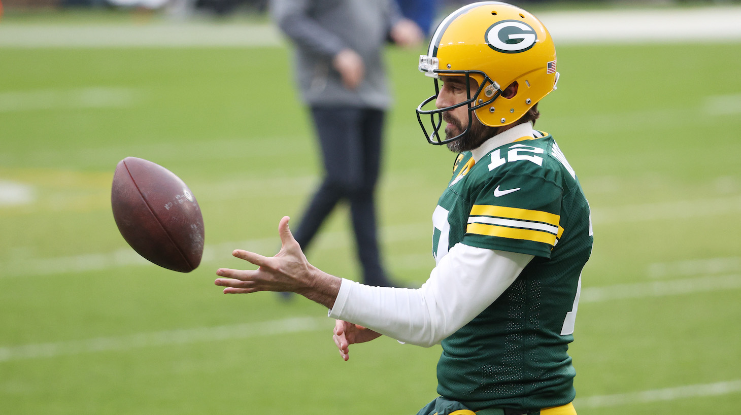 GREEN BAY, WISCONSIN - JANUARY 24: Aaron Rodgers #12 of the Green Bay Packers warms up prior to their NFC Championship game against the Tampa Bay Buccaneers at Lambeau Field on January 24, 2021 in Green Bay, Wisconsin. (Photo by Dylan Buell/Getty Images)