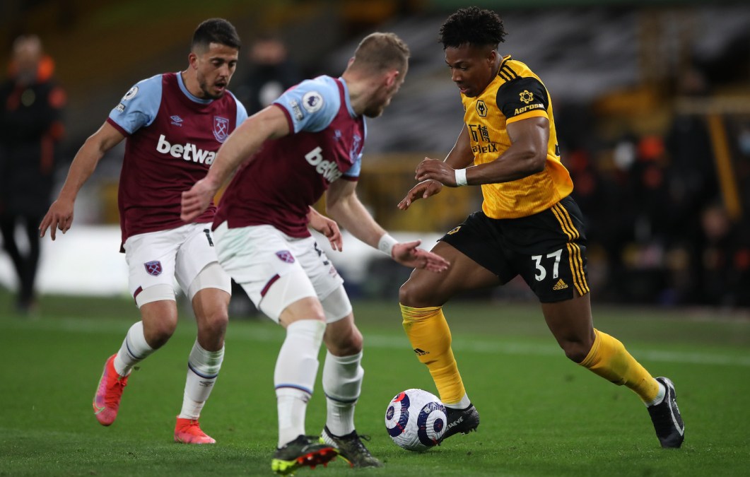 Adama Traore of Wolverhampton Wanderers is challenged by Pablo Fornals and Vladimir Coufal of West Ham during the Premier League match between Wolverhampton Wanderers and West Ham United at Molineux on April 05, 2021 in Wolverhampton, England.