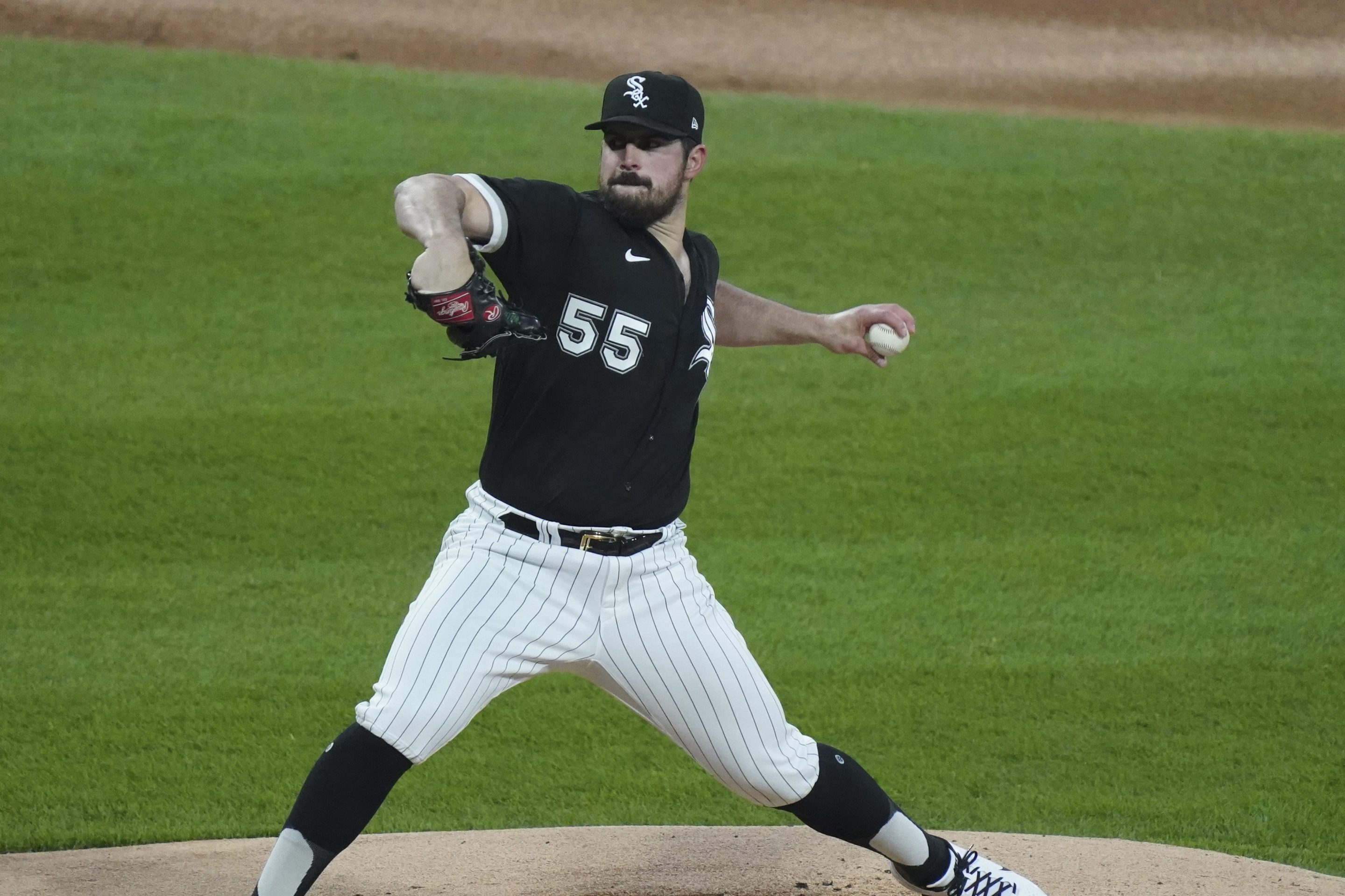 Carlos Rodon stretches through his pitching motion toward home.