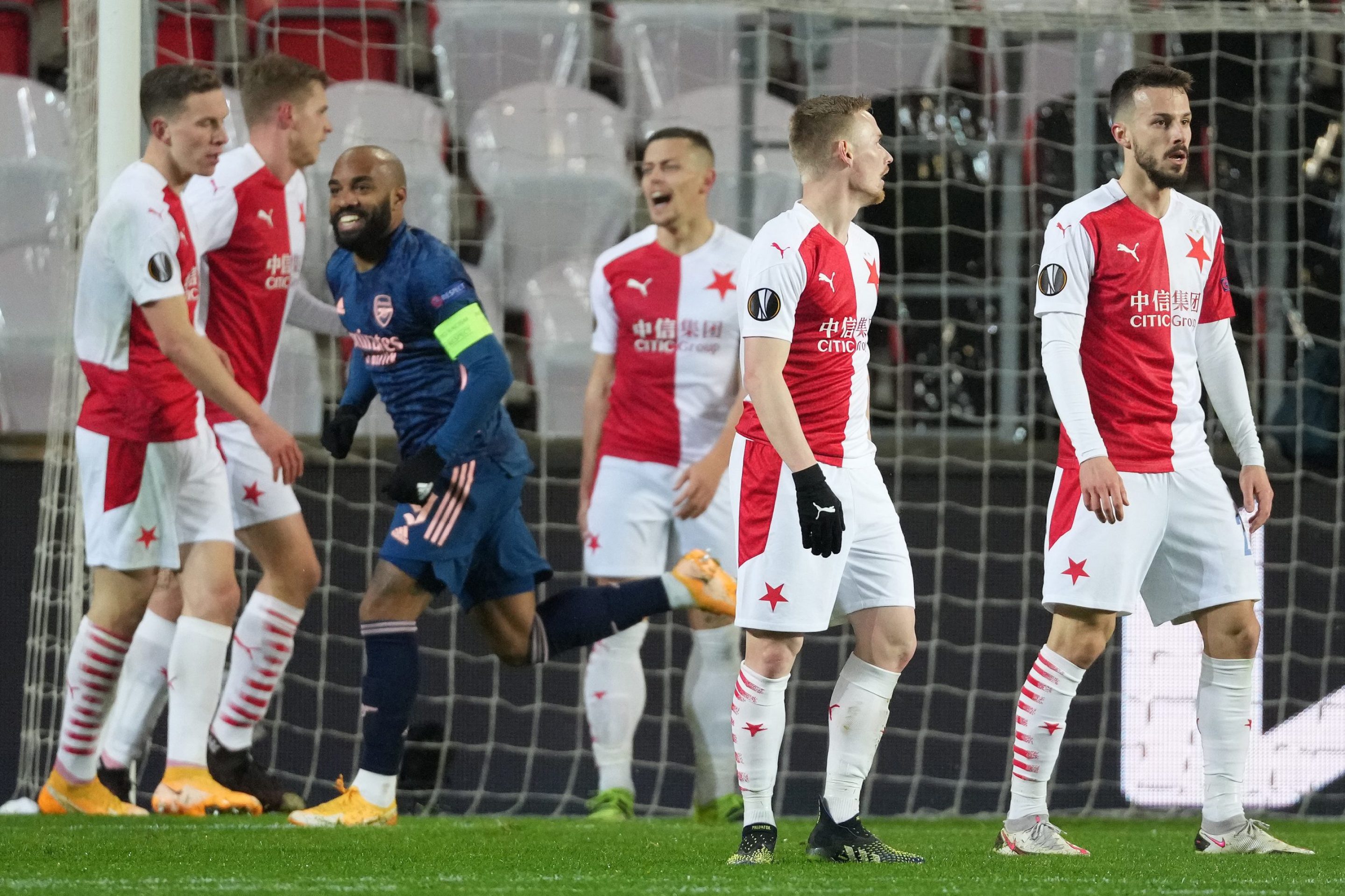 Players of Slavia Praha look dejected after Alexandre Lacazette of Arsenal scored his team's second goal from the penalty spot during the UEFA Europa League Quarter Final Second Leg match between Slavia Praha and Arsenal FC at Sinobo Stadium on April 15, 2021 in Prague, Czech Republic