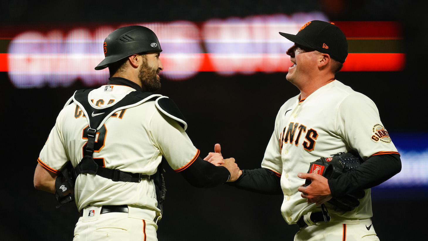 SAN FRANCISCO, CALIFORNIA - APRIL 22: Jake McGee #17 and Curt Casali #2 of the San Francisco Giants celebrate beating the Miami Marlins at Oracle Park on April 22, 2021 in San Francisco, California. (Photo by Daniel Shirey/Getty Images)