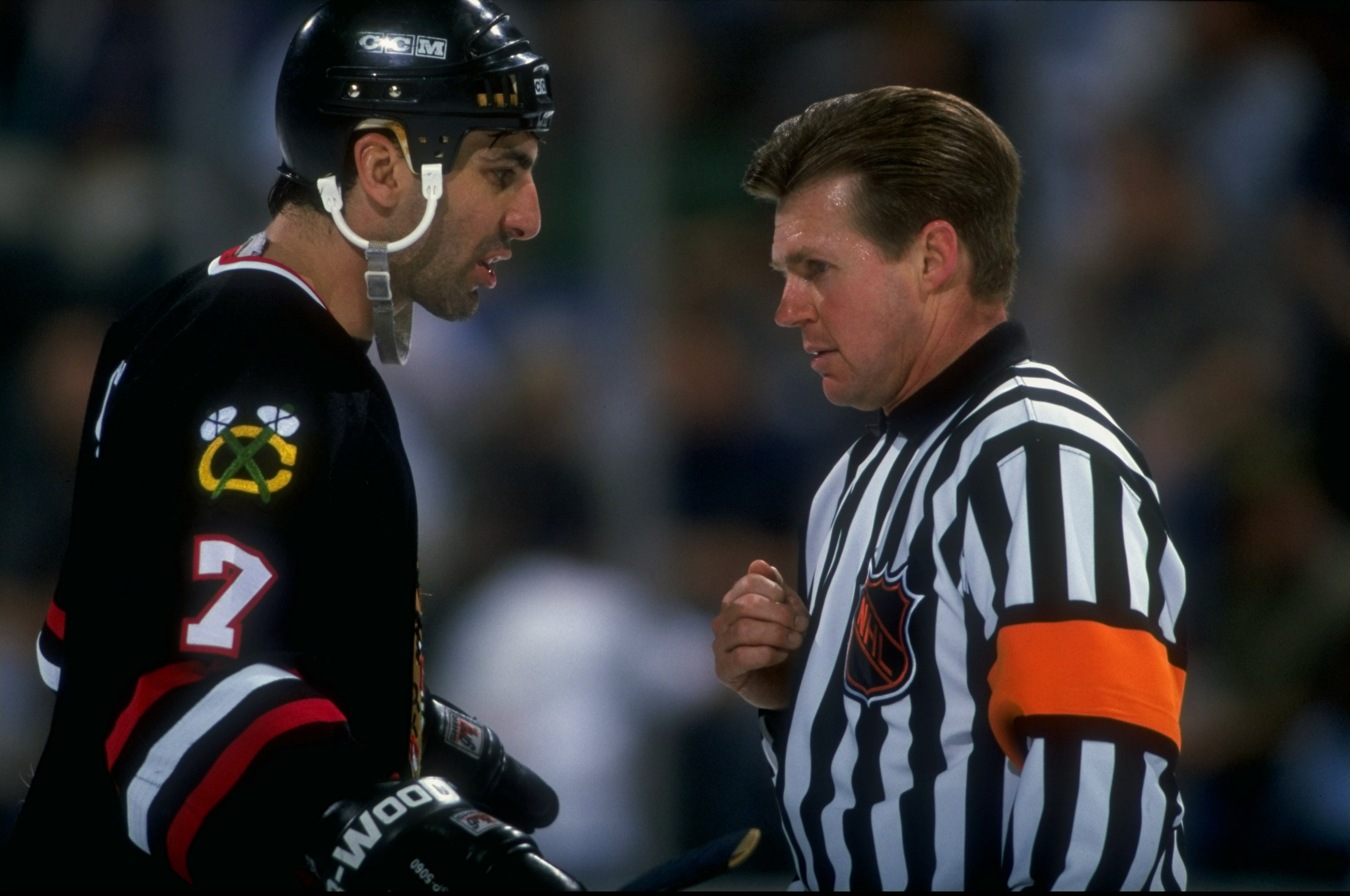 Chris Chelios talks with a referee