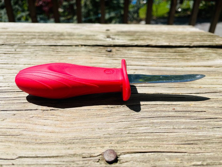 A New Haven-style oyster knife with a red handle