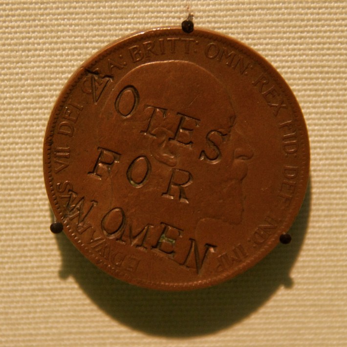 A suffragette-defaced penny is stamped with "VOTES FOR WOMEN."