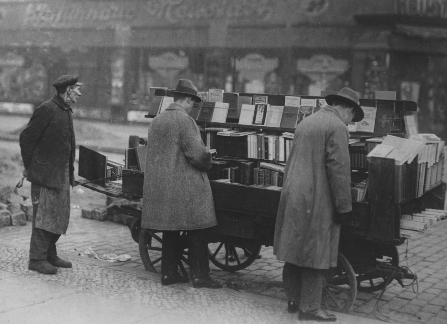 Customers browse at a mobile book stall, Berlin, circa 1925.