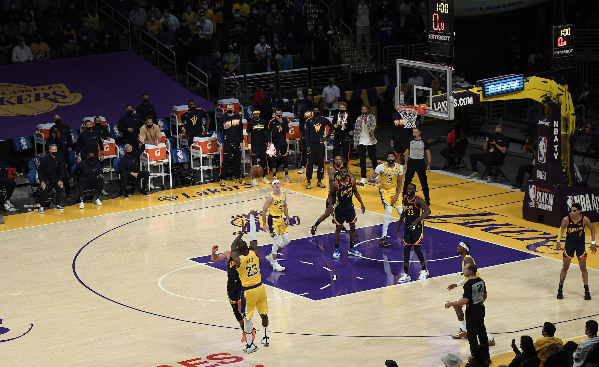 LOS ANGELES, CA - MAY 19: LeBron James #23 of the Los Angeles Lakers scores the game winning three point basket against Stephen Curry #30 of the Golden State Warriors in the closing minute of an NBA Tournament Play-In game at Staples Center on May 19, 2021 in Los Angeles, California. NOTE TO USER: User expressly acknowledges and agrees that, by downloading and or using this photograph, User is consenting to the terms and conditions of the Getty Images License Agreement. (Photo by Kevork Djansezian/Getty Images)