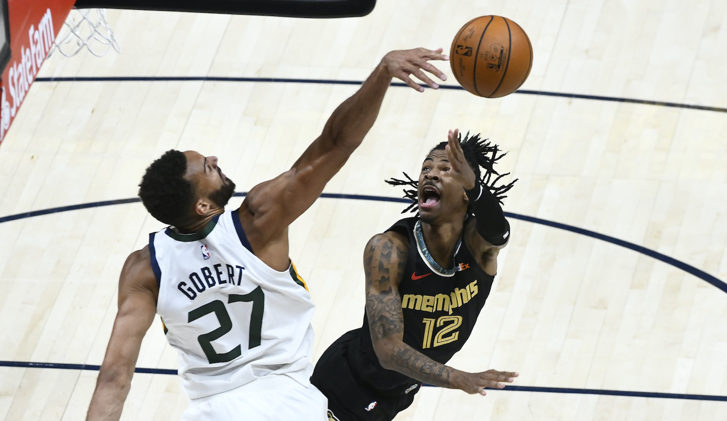 SALT LAKE CITY, UTAH - MAY 23: Rudy Gobert #27 of the Utah Jazz blocks Ja Morant #12 of the Memphis Grizzlies in Game One of the Western Conference first-round playoff series at Vivint Smart Home Arena on May 23, 2021 in Salt Lake City, Utah. NOTE TO USER: User expressly acknowledges and agrees that, by downloading and/or using this photograph, user is consenting to the terms and conditions of the Getty Images License Agreement. (Photo by Alex Goodlett/Getty Images)