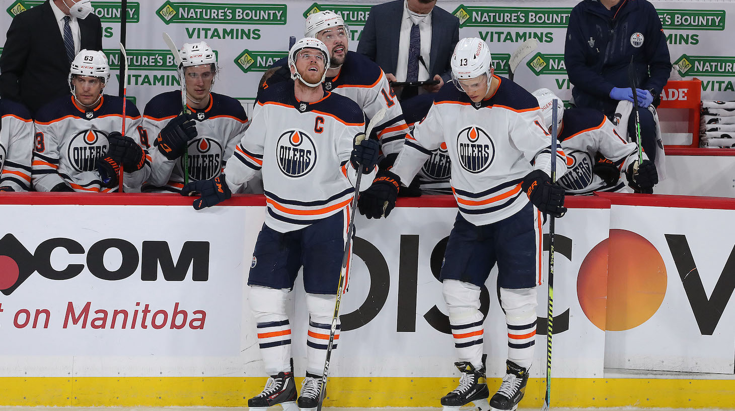 WINNIPEG, MANITOBA - MAY 23: Connor McDavid #97 and Jesse Puljujarvi #13 of the Edmonton Oilers react after the Jets tied up Game Three of the First Round of the 2021 Stanley Cup Playoffs against the Winnipeg Jets on May 23, 2021 at Bell MTS Place in Winnipeg, Manitoba, Canada. (Photo by Jason Halstead/Getty Images)