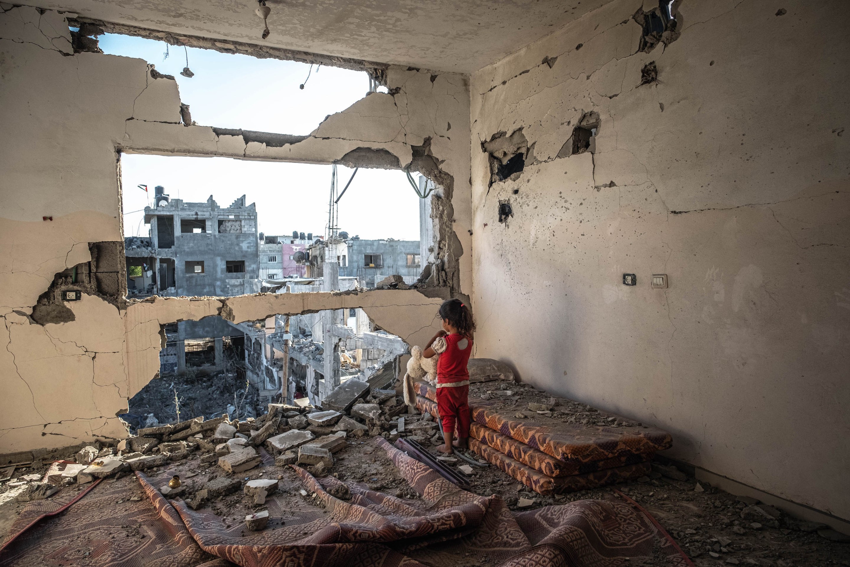 A Palestinian girl stands amid the rubble of her destroyed house in Beit Hanun town northern Gaza Strip,on May 24, 2021 in Gaza City, Gaza