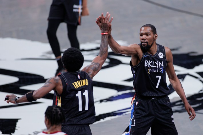 Kyrie Irving and Kevin Durant exchange a high-five