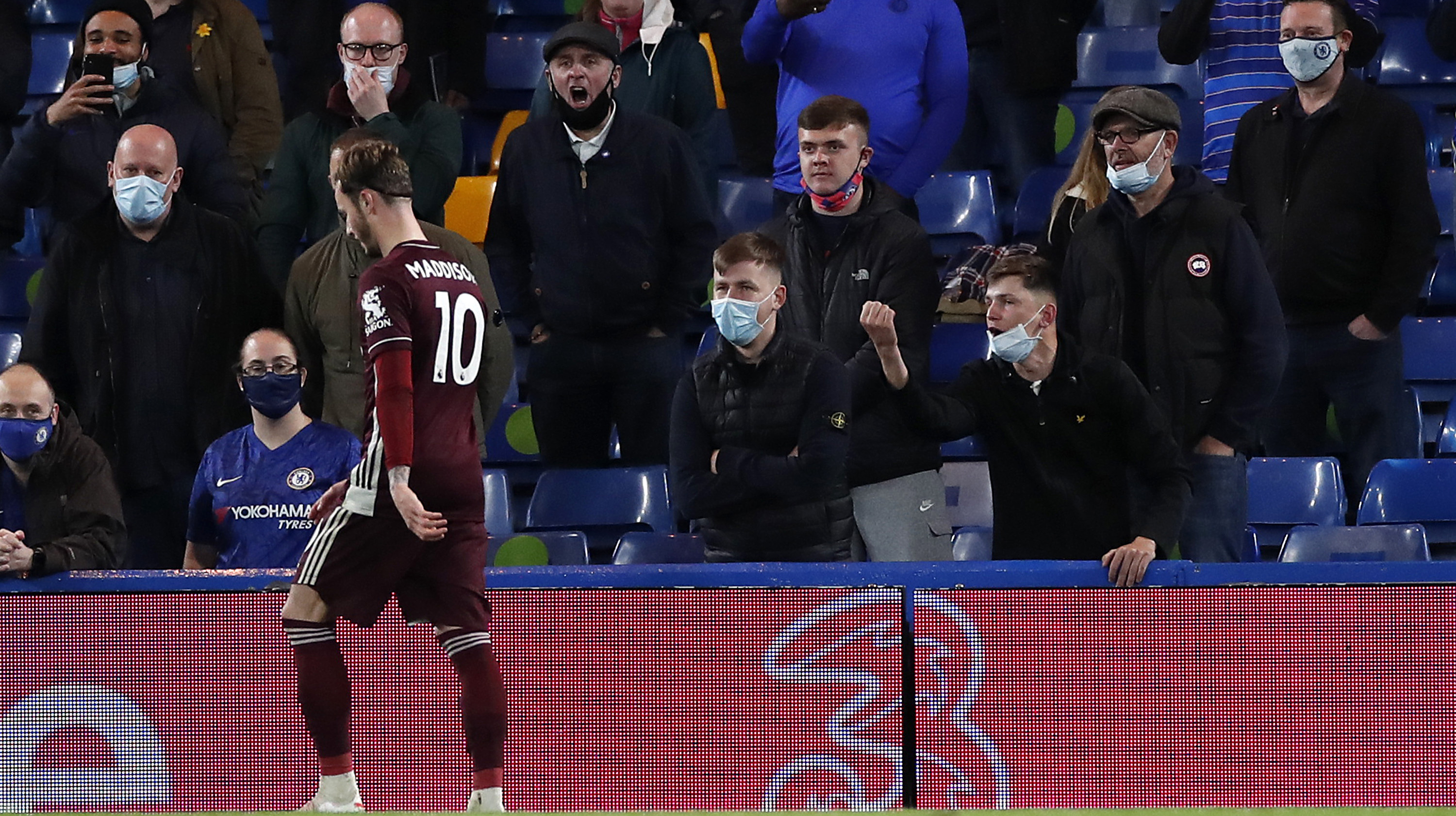 A member of the crowd gestures towards James Maddison of Leicester City during the Premier League match between Chelsea and Leicester City at Stamford Bridge on May 18, 2021 in London, England.