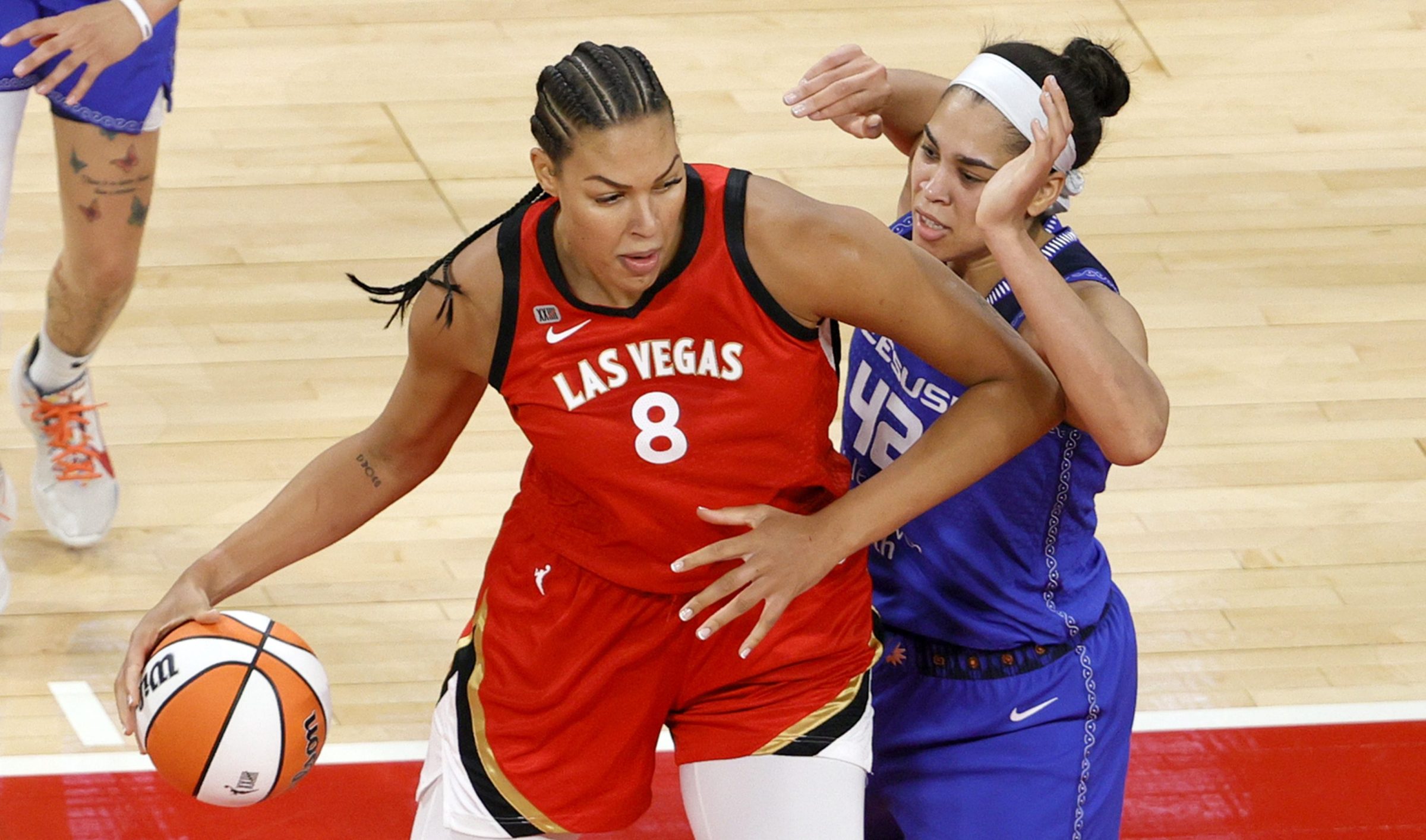 Liz Cambage #8 of the Las Vegas Aces is guarded by Brionna Jones #42 of the Connecticut Sun during their game at Michelob ULTRA Arena on May 23, 2021 in Las Vegas, Nevada. The Sun defeated the Aces 72-65.