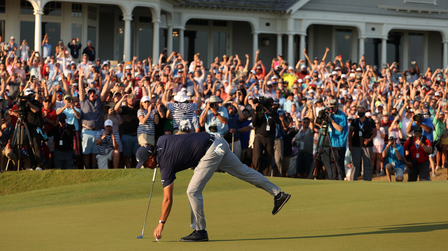 KIAWAH ISLAND, SOUTH CAROLINA - MAY 23: Phil Mickelson of the United States retrieves his golf ball on the 18th green after putting to win during the final round of the 2021 PGA Championship held at the Ocean Course of Kiawah Island Golf Resort on May 23, 2021 in Kiawah Island, South Carolina. (Photo by Patrick Smith/Getty Images)