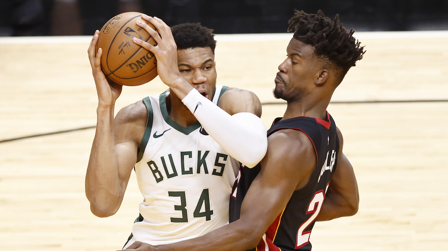 MIAMI, FLORIDA - MAY 27: Giannis Antetokounmpo #34 of the Milwaukee Bucks drives to the basket against Jimmy Butler #22 of the Miami Heat during the third quarter in Game Three of the Eastern Conference first-round playoff series at American Airlines Arena on May 27, 2021 in Miami, Florida. NOTE TO USER: User expressly acknowledges and agrees that, by downloading and or using this photograph, User is consenting to the terms and conditions of the Getty Images License Agreement. (Photo by Michael Reaves/Getty Images)