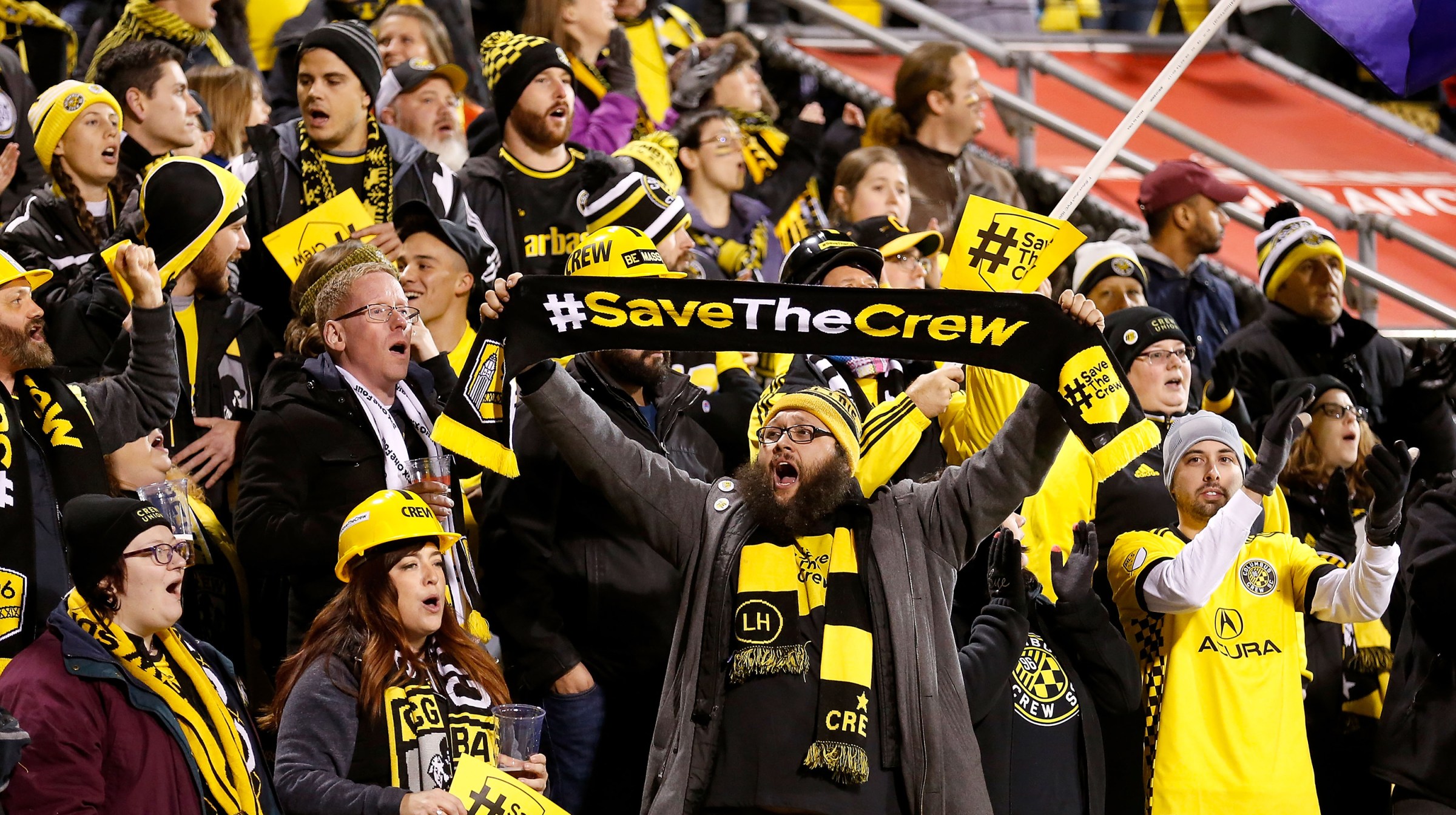 A fan of the Columbus Crew SC holds up a scarf showing his support for keeping the team in Columbus prior to the start of the match between the Columbus Crew SC and the Toronto FC at MAPFRE Stadium on November 21, 2017 in Columbus, Ohio.