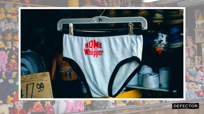 A pair of speedo swim trunks that say "HOME OF THE WHOPPER" on them