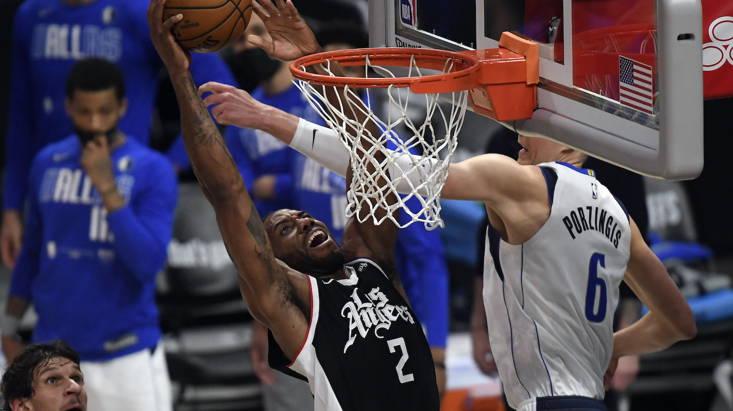 LOS ANGELES, CA - JUNE 06: Kawhi Leonard #2 of the Los Angeles Clippers dunks the ball against Kristaps Porzingis #6 of the Dallas Mavericks during the second half of Game Seven of the Western Conference first round series at Staples Center on June 6, 2021 in Los Angeles, California. NOTE TO USER: User expressly acknowledges and agrees that, by downloading and or using this photograph, User is consenting to the terms and conditions of the Getty Images License Agreement. (Photo by Kevork Djansezian/Getty Images)