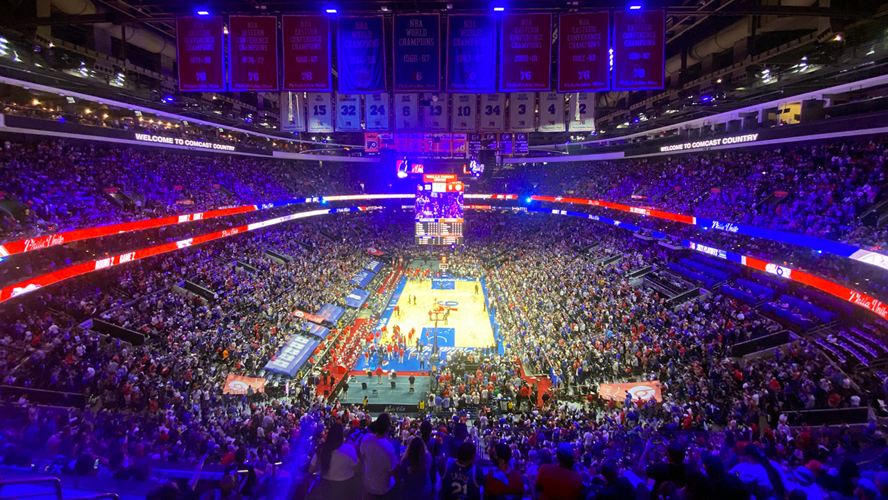 The 76ers arena with the Sixers up 23-6 early in a playoff game. It's full and looks loud. It's a wide shot, with a wide angle lense