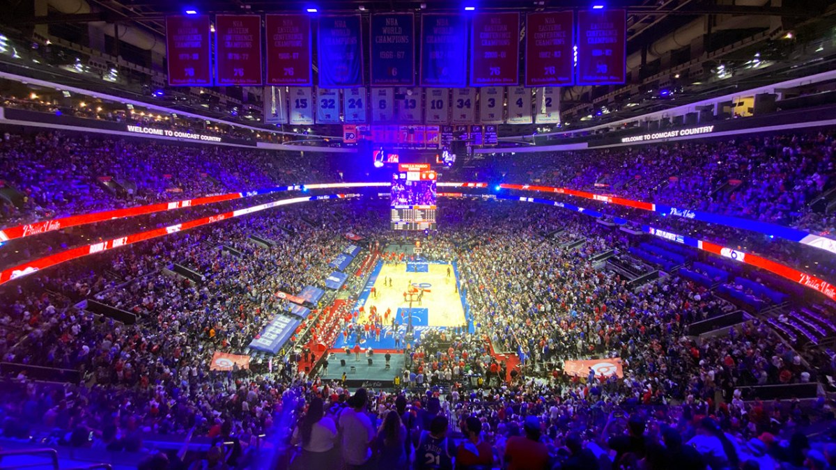The 76ers arena with the Sixers up 23-6 early in a playoff game. It's full and looks loud. It's a wide shot, with a wide angle lense