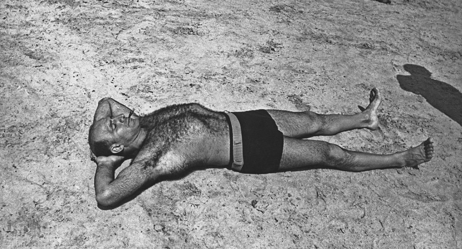 A man sunbathes, circa 1940