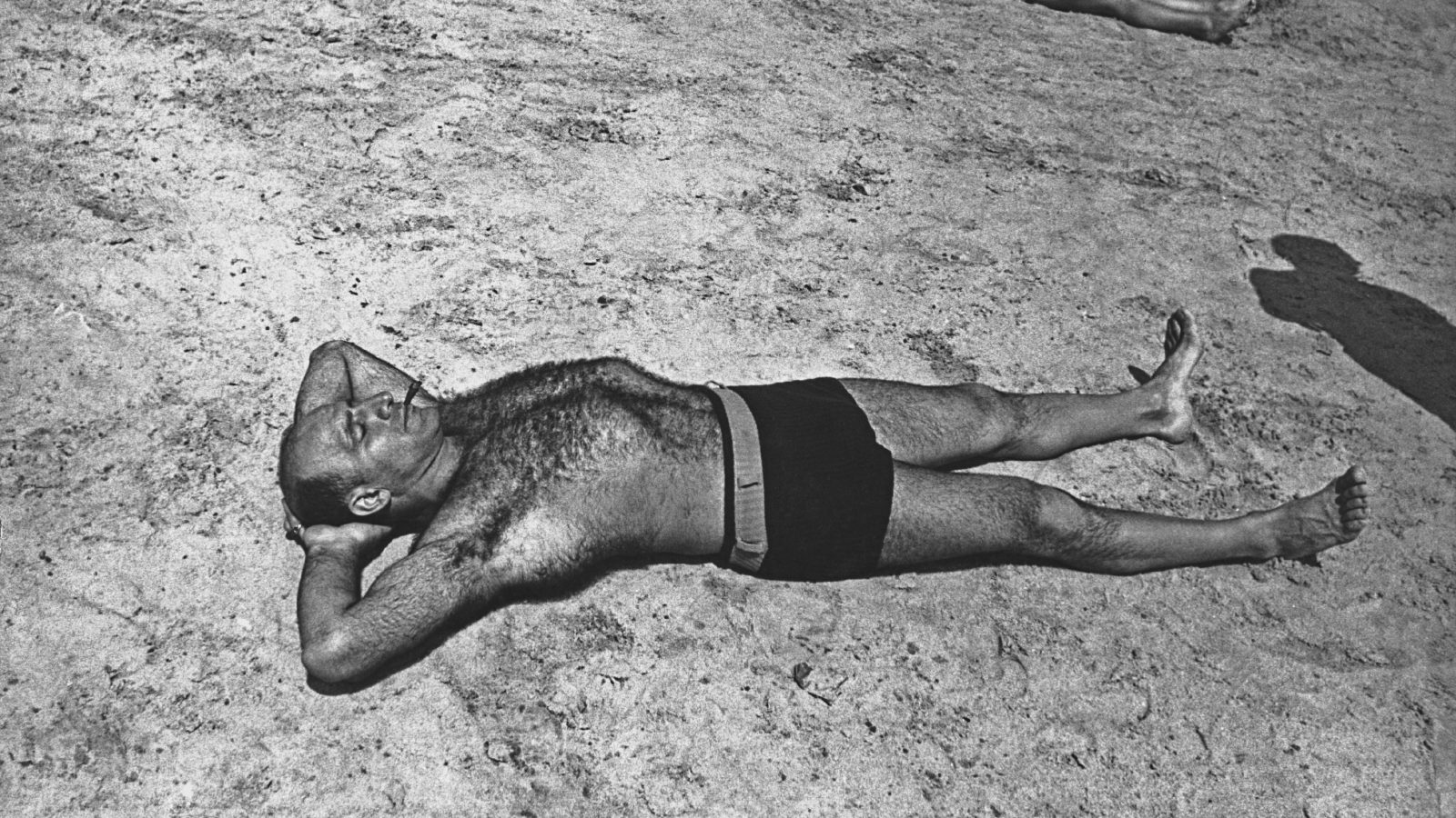 A man sunbathes, circa 1940