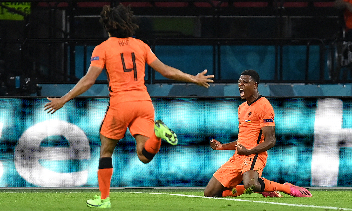 Netherlands' defender Denzel Dumfries (R) celebrates after scoring the third goal during the UEFA EURO 2020 Group C football match between the Netherlands and Ukraine at the Johan Cruyff Arena in Amsterdam on June 13, 2021.