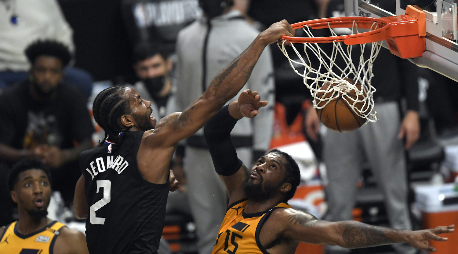 LOS ANGELES, CA - JUNE 14: Kawhi Leonard #2 of the Los Angeles Clippers slam dunks against Derrick Favors #15 of the Utah Jazz during the first half in Game Four of the Western Conference second-round playoff series at Staples Center on June 14, 2021 in Los Angeles, California. NOTE TO USER: User expressly acknowledges and agrees that, by downloading and or using this photograph, User is consenting to the terms and conditions of the Getty Images License Agreement. (Photo by Kevork Djansezian/Getty Images)