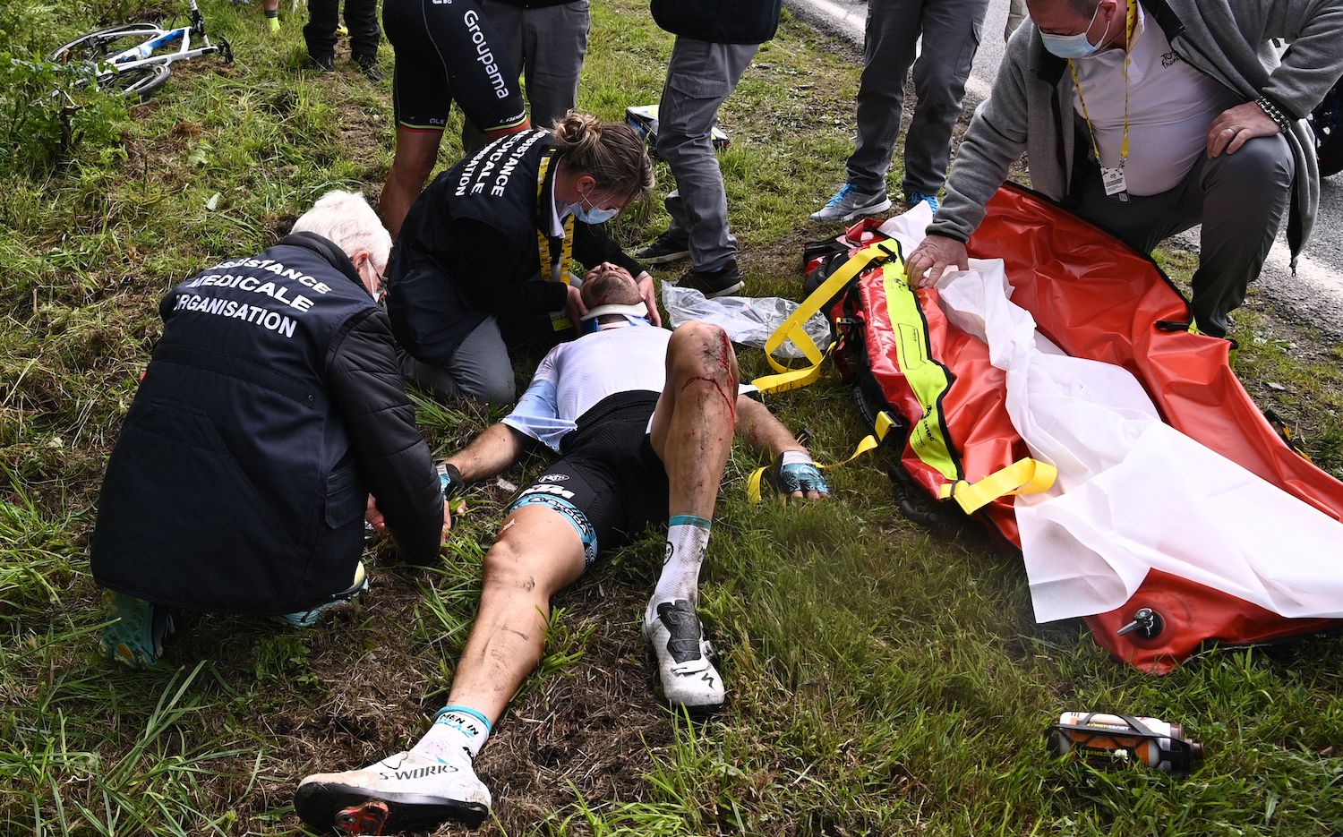 Team B&B KTM's Cyril Lemoine of France is helped by medical staff members after crashing during the 1st stage of the 108th edition of the Tour de France cycling race, 197 km between Brest and Landerneau, on June 26, 2021. (Photo by Anne-Christine POUJOULAT / POOL / AFP) (Photo by ANNE-CHRISTINE POUJOULAT/POOL/AFP via Getty Images)