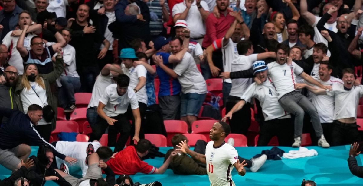 England's forward Raheem Sterling (L) celebrates after scoring the opening goal during the UEFA EURO 2020 round of 16 football match between England and Germany at Wembley Stadium in London on June 29, 2021.