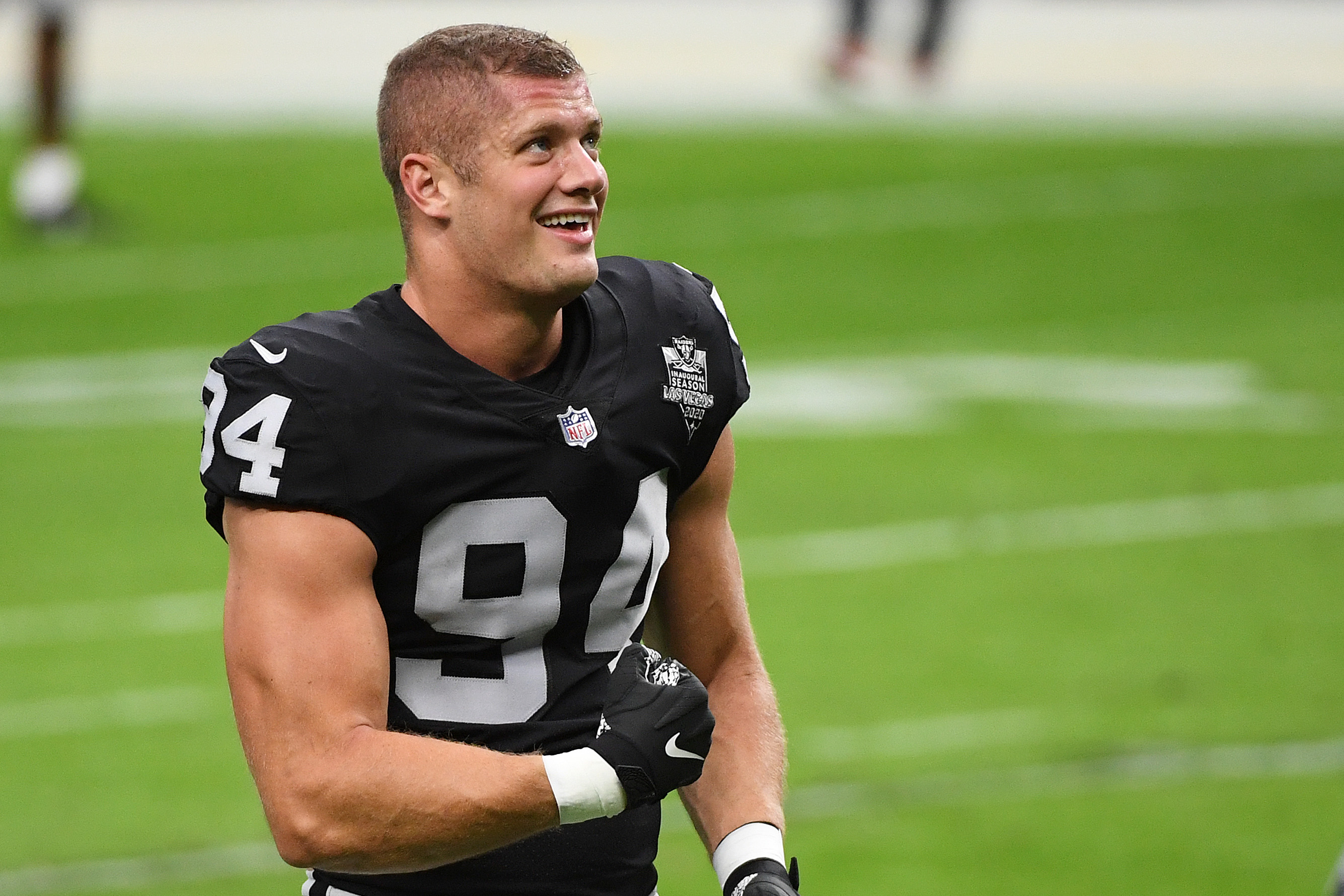 Carl Nassib flexes and smiles