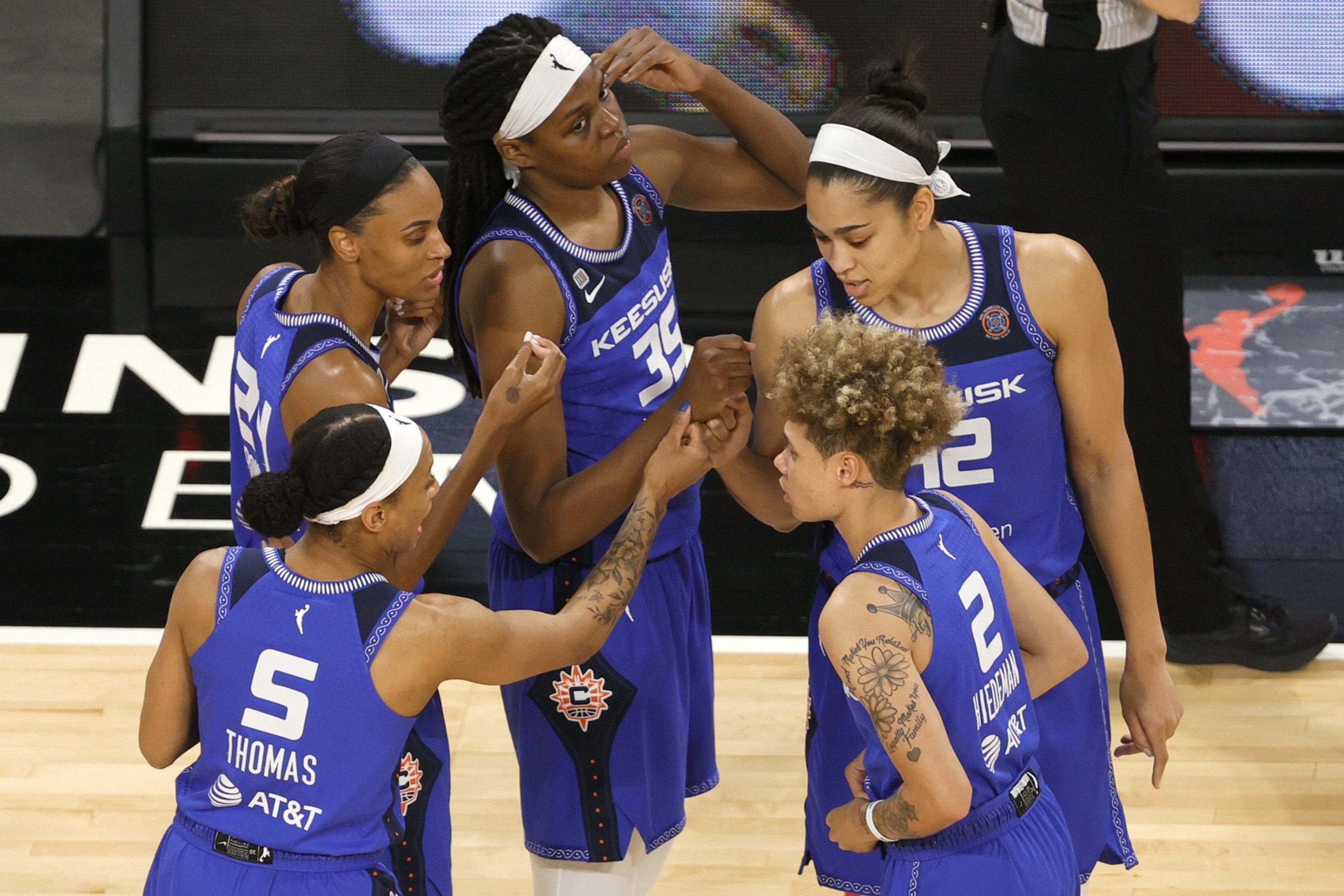 Jasmine Thomas #5, DeWanna Bonner #24, Jonquel Jones #35, Natisha Hiedeman #2 and Brionna Jones #42 of the Connecticut Sun huddle on the court before their game against the Las Vegas Aces at Michelob ULTRA Arena on May 23, 2021 in Las Vegas, Nevada. The Sun defeated the Aces 72-65.