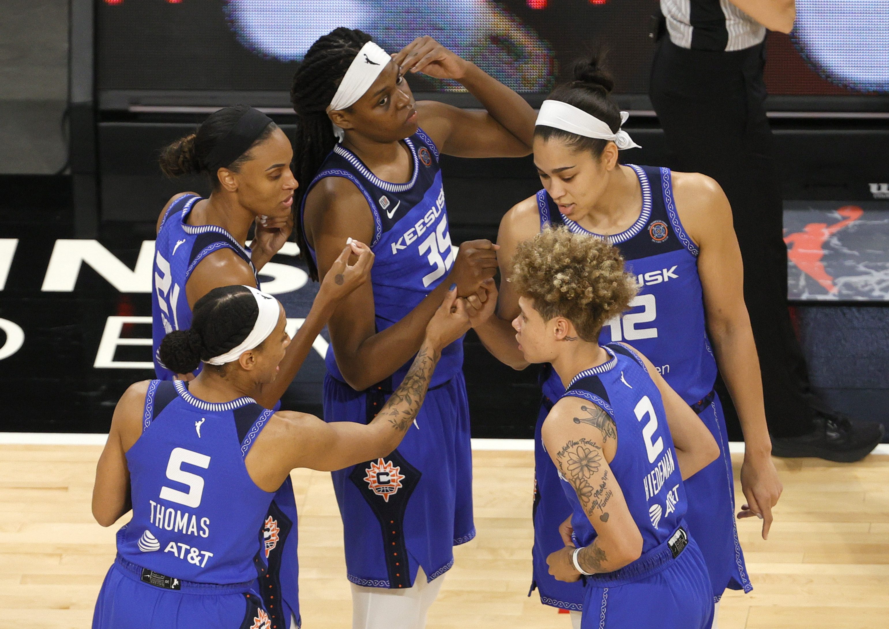 Jasmine Thomas #5, DeWanna Bonner #24, Jonquel Jones #35, Natisha Hiedeman #2 and Brionna Jones #42 of the Connecticut Sun huddle on the court before their game against the Las Vegas Aces at Michelob ULTRA Arena on May 23, 2021 in Las Vegas, Nevada. The Sun defeated the Aces 72-65.