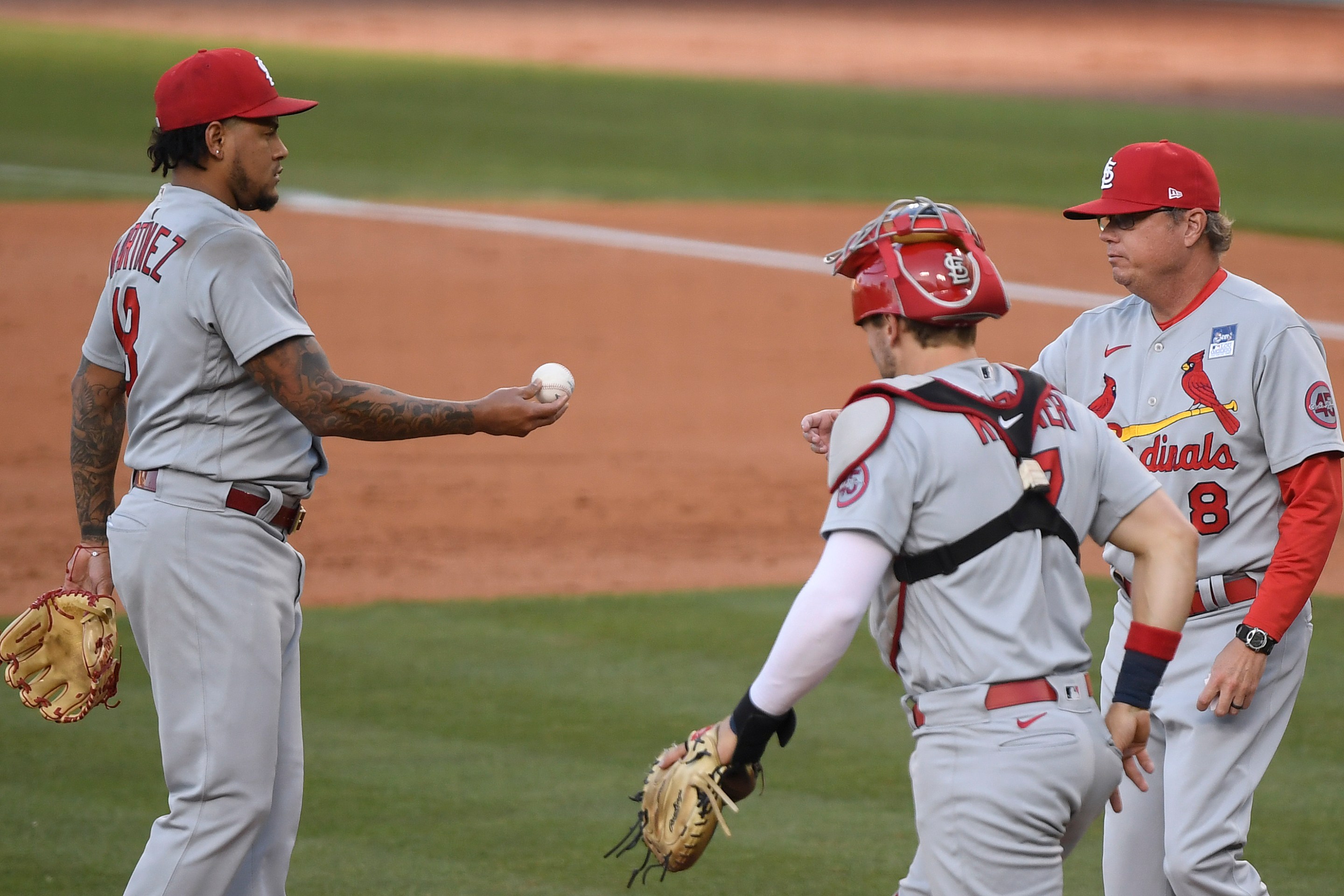 A shell-shocked Carlos Martinez hands the ball to manager Mike Shildt after registering just two outs.