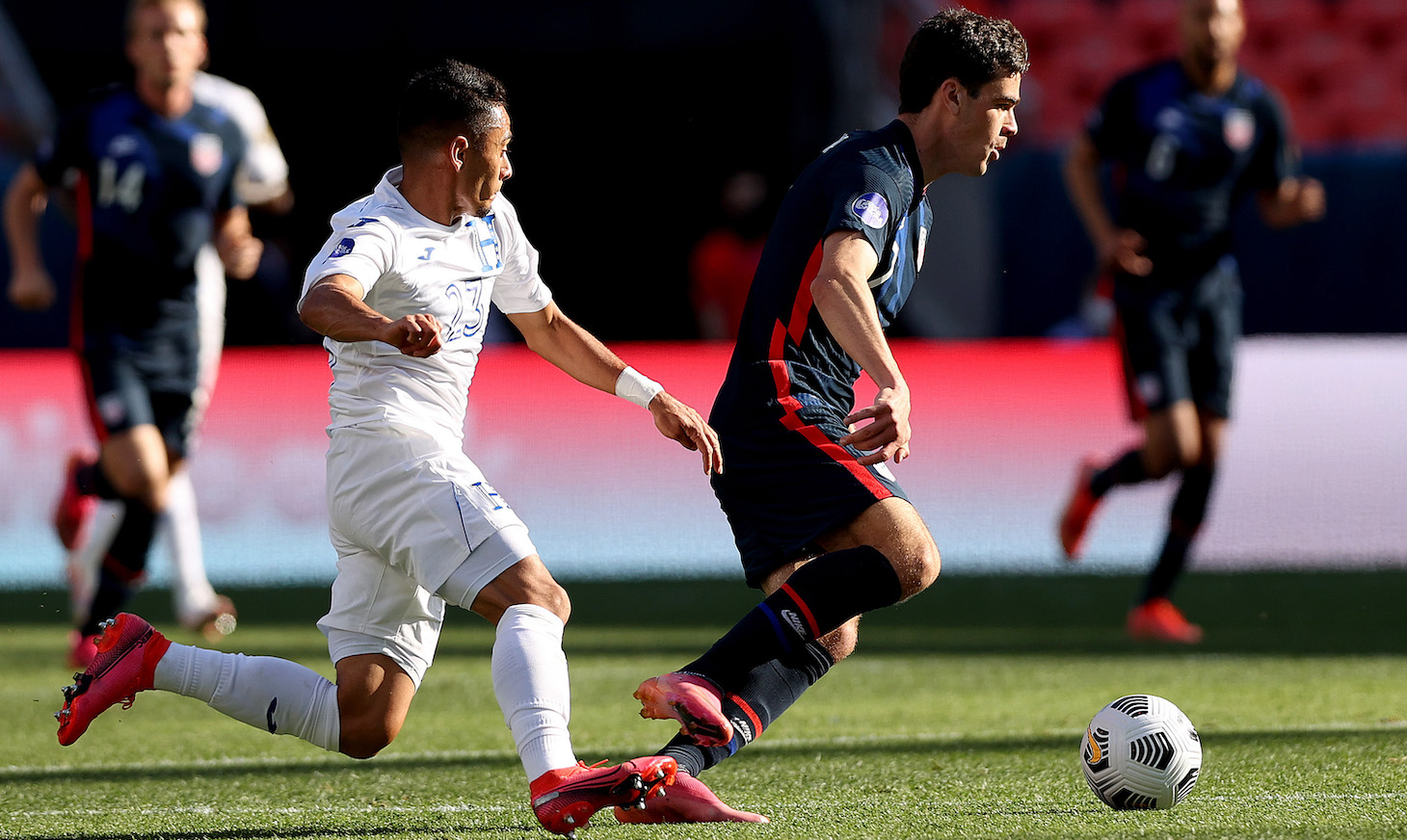 Gio Reyna #7 of USA advances the ball against Diego Rodriguez #23 of Honduras in the first half during Game 1 of the Semifinals of the CONCACAF Nations League Finals of at Empower Field At Mile High on June 03, 2021 in Denver, Colorado.