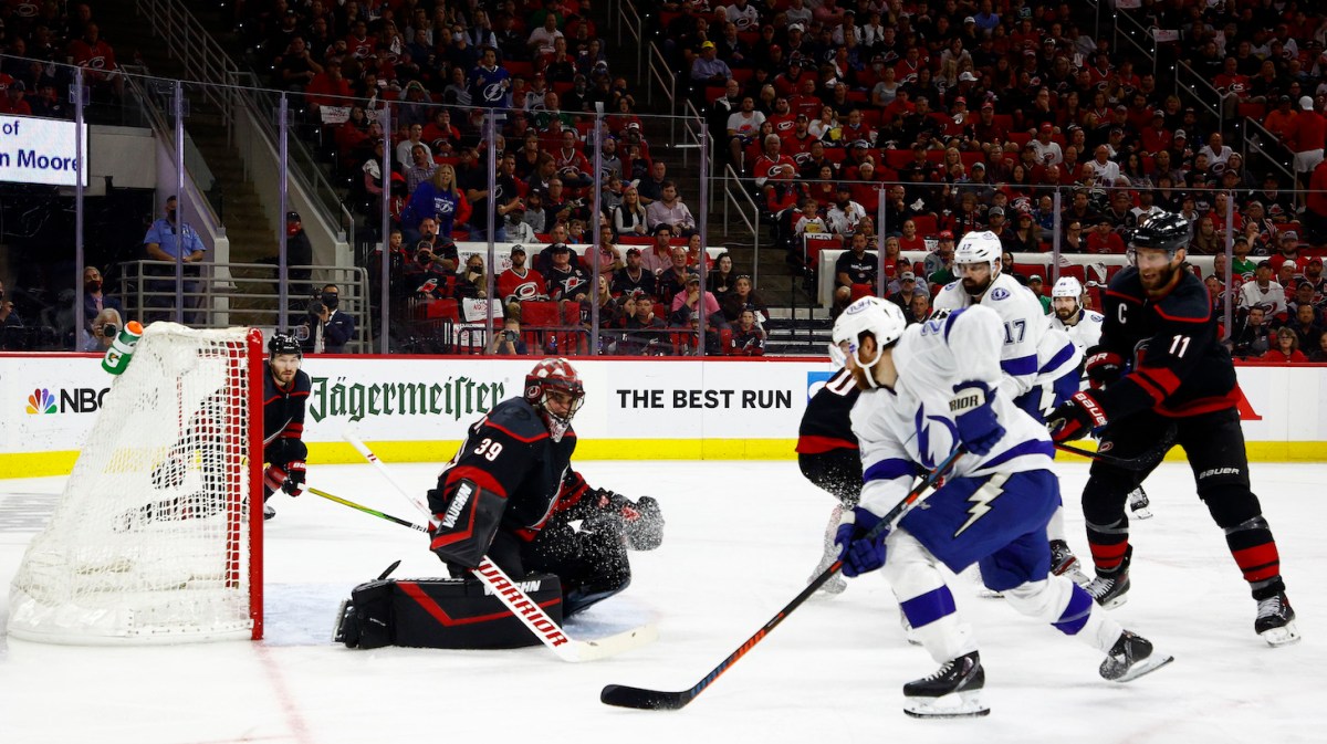 RALEIGH, NORTH CAROLINA - JUNE 08: Brayden Point #21 of the Tampa Bay Lightning shoots and scores against Alex Nedeljkovic #39 of the Carolina Hurricanes during the second period in Game Five of the Second Round of the 2021 Stanley Cup Playoffs at PNC Arena on June 08, 2021 in Raleigh, North Carolina. (Photo by Jared C. Tilton/Getty Images)
