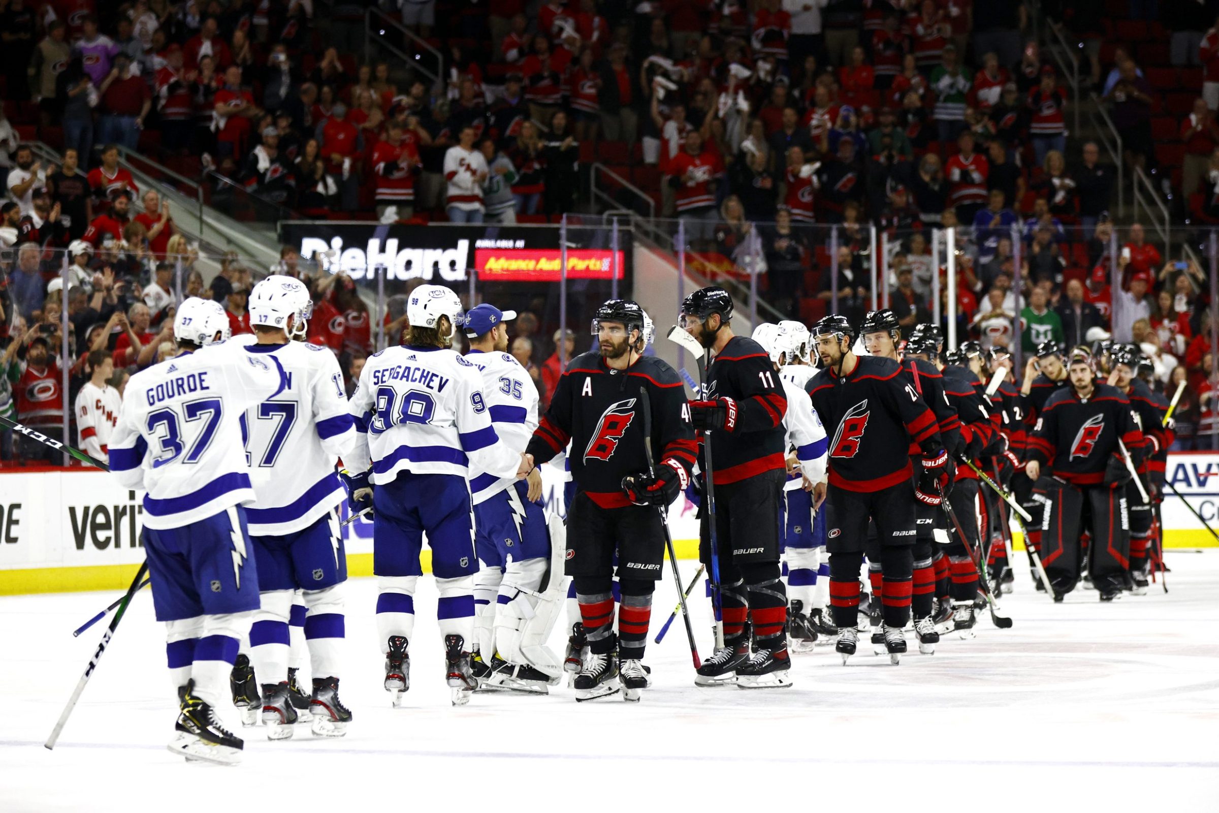 the Lightning shake hands with the Hurricanes