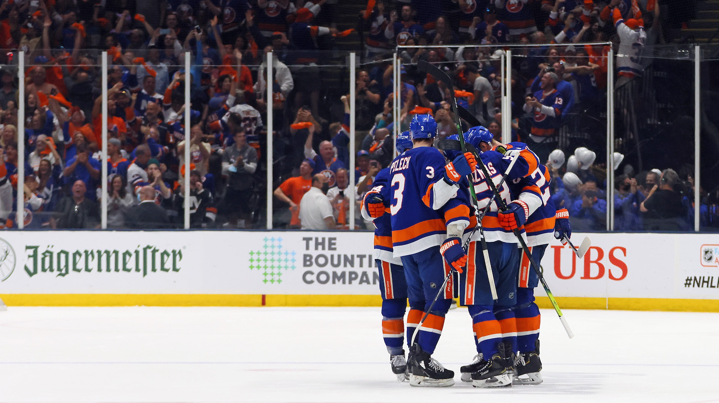 UNIONDALE, NEW YORK - JUNE 09: The New York Islanders celebrate an empty net goal by Cal Clutterbuck #15 of the New York Islanders against the Boston Bruins in Game Six of the Second Round of the 2021 NHL Stanley Cup Playoffs at the Nassau Coliseum on June 09, 2021 in Uniondale, New York. The Islanders defeated the Bruins 6-2 to move on to the Stanley Cup Semifinals against the Tampa Bay Lightning. (Photo by Bruce Bennett/Getty Images)