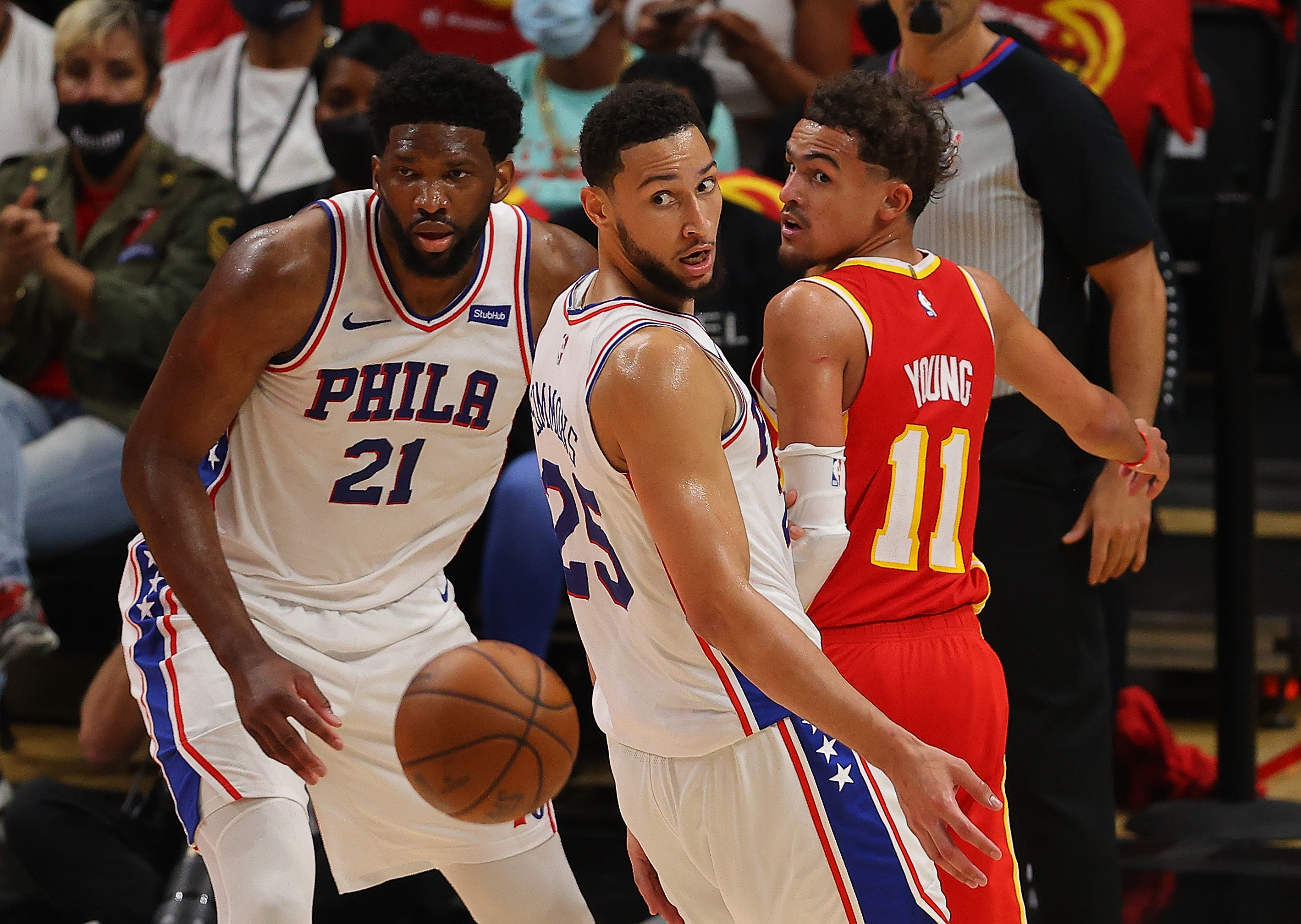 Joel Embiid, Ben Simmons, and Trae Young watch the ball.