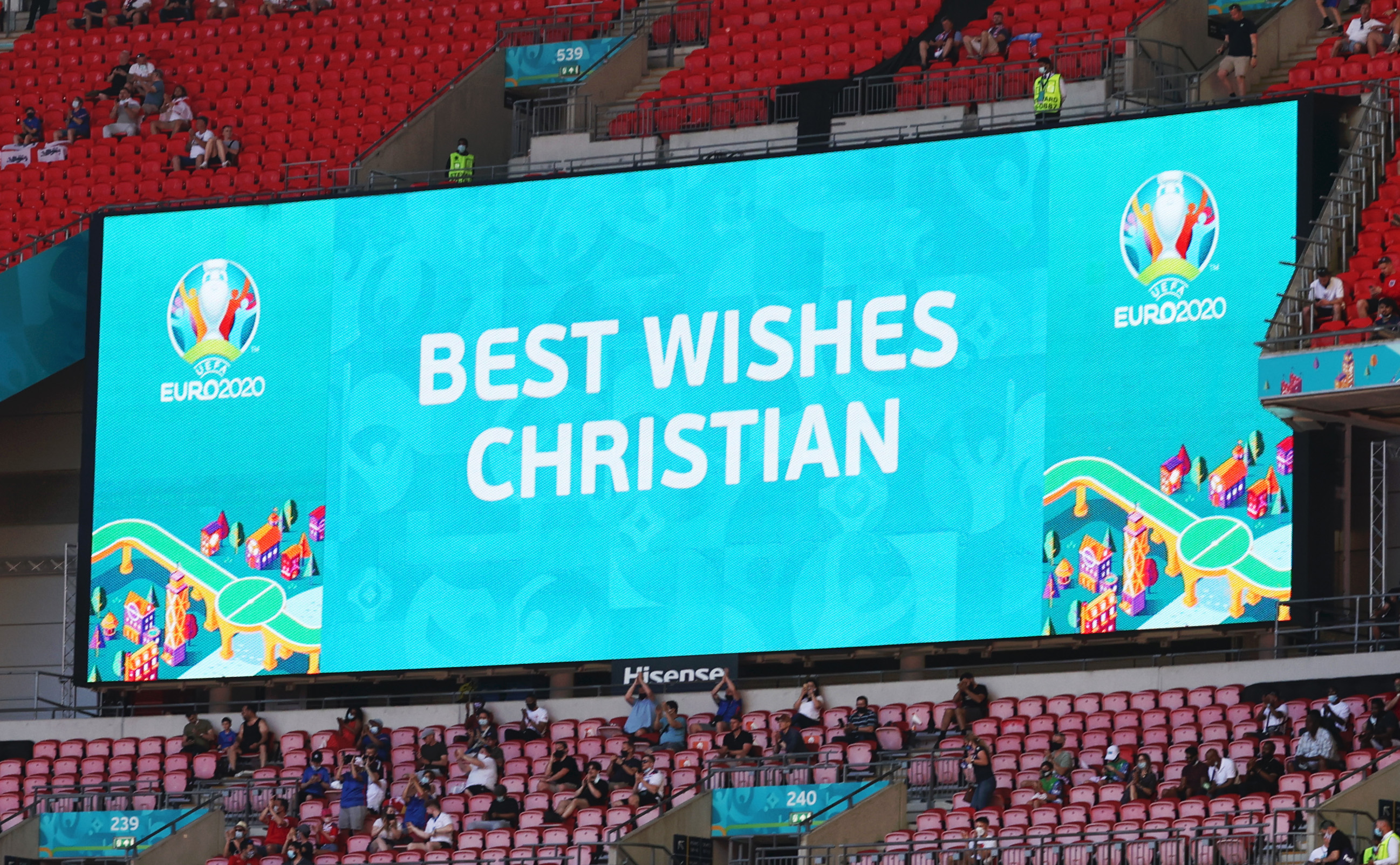 A stadiums screen shows shows a message of support for Christian Eriksen