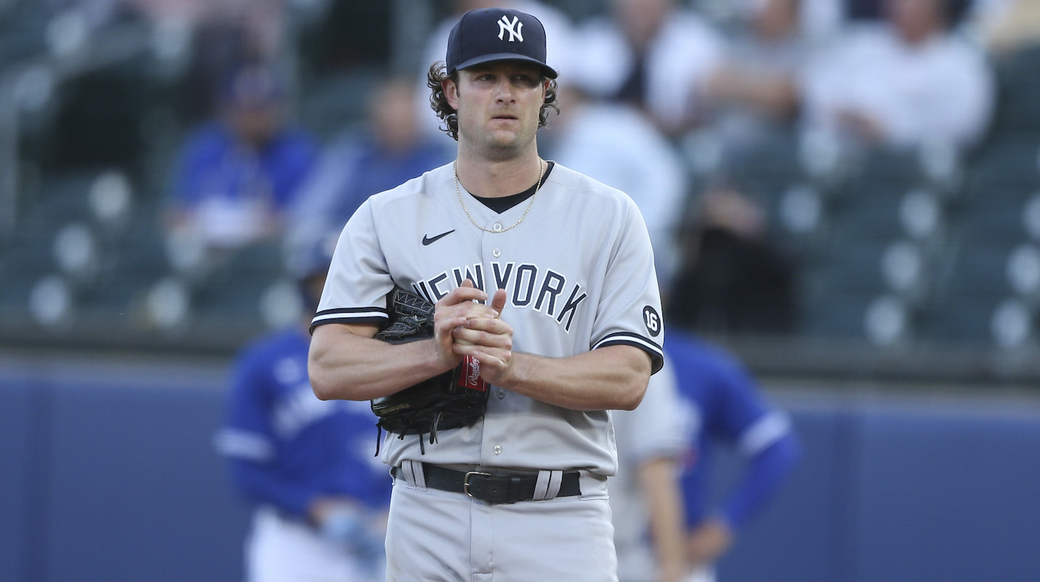 BUFFALO, NEW YORK - JUNE 16: Gerrit Cole #45 of the New York Yankees rubs the ball between pitches during the second inning against the Toronto Blue Jays at Sahlen Field on June 16, 2021 in Buffalo, New York. (Photo by Joshua Bessex/Getty Images)