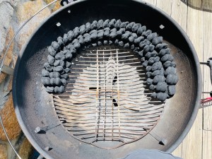 A two-layer double row of charcoal, around the inside edge of a charcoal kettle grill.
