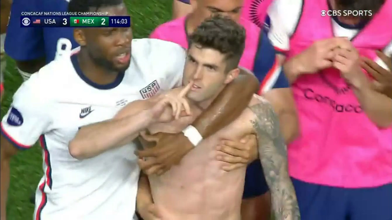 A shirtless Christian Pulisic celebrates his badass, game-winning penalty goal with his USMNT teammates.
