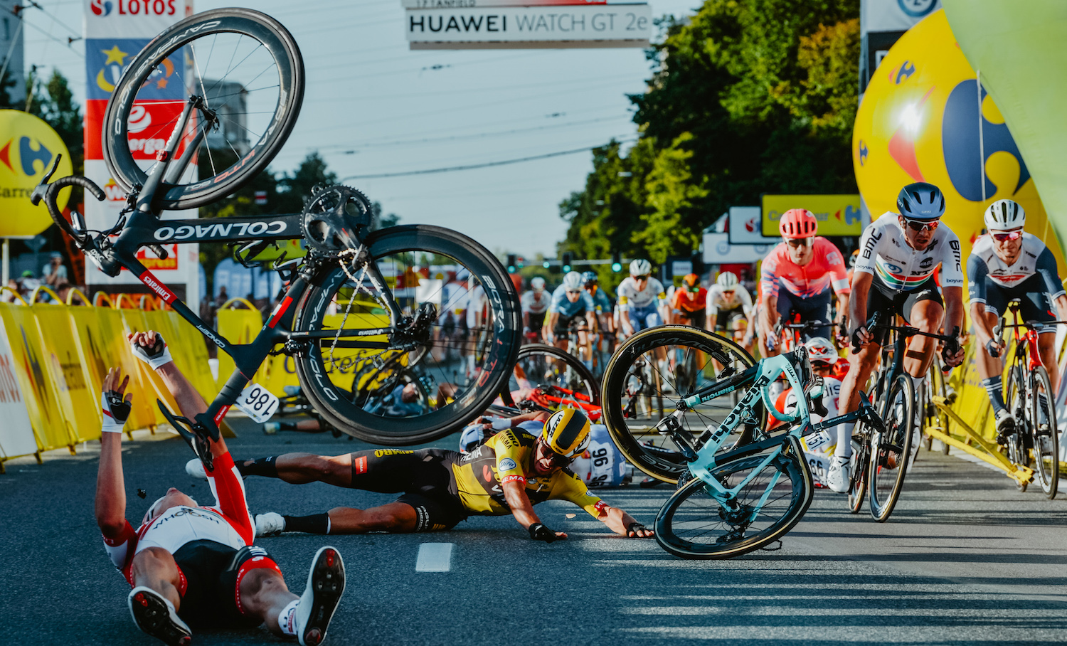TOPSHOT - Dutch cyclist Dylan Groenewegen (on the ground ,C) and fellow riders collide during the opening stage of the Tour of Poland race in Katowice , southern Poland on August 5, 2020. - Dutch rider Fabio Jakobsen was fighting for his life on Wednesday after he was thrown into and over a barrier at 80km/h in a sickening conclusion to the opening stage of the Tour of Poland. (Photo by Szymon Gruchalski / Forum / AFP) (Photo by SZYMON GRUCHALSKI/Forum/AFP via Getty Images)