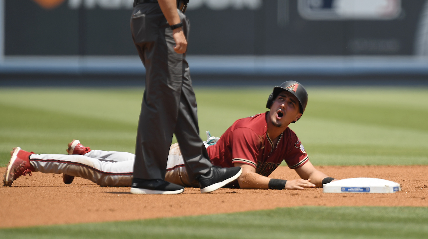 LOS ANGELES, CA - JULY 11: Josh Rojas #10 of the Arizona Diamondbacks reacts to second base umpire Brian O'Nora #7 after he was called out trying to steal second base against the Los Angeles Dodgers during the first inning at Dodger Stadium on July 11, 2021 in Los Angeles, California. (Photo by Kevork Djansezian/Getty Images)