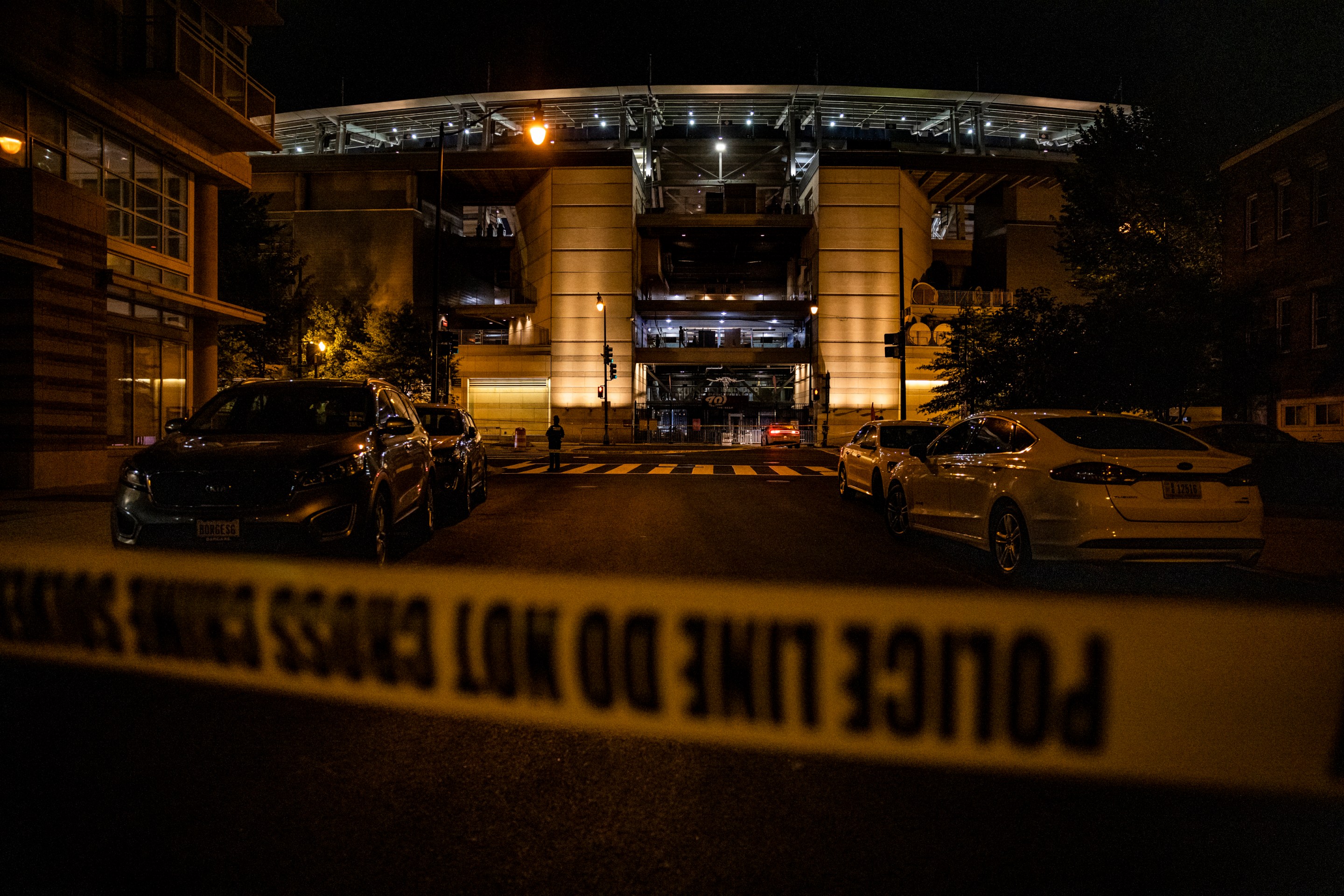 A photo of police tape and police cars in front of Nationals Park