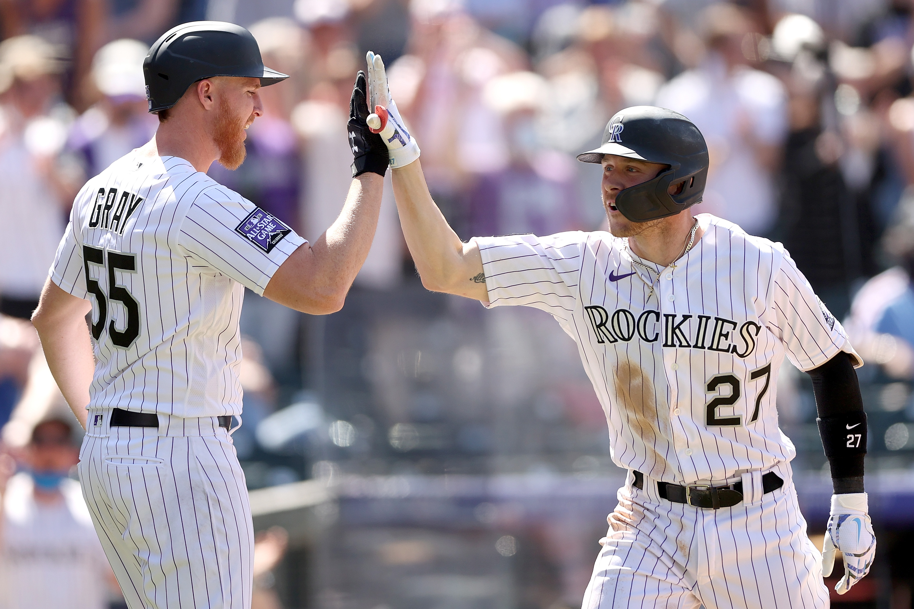 Rockies pitcher Jon Gray and Rockies shortstop Trevor Story high-five in a game against the Phillies