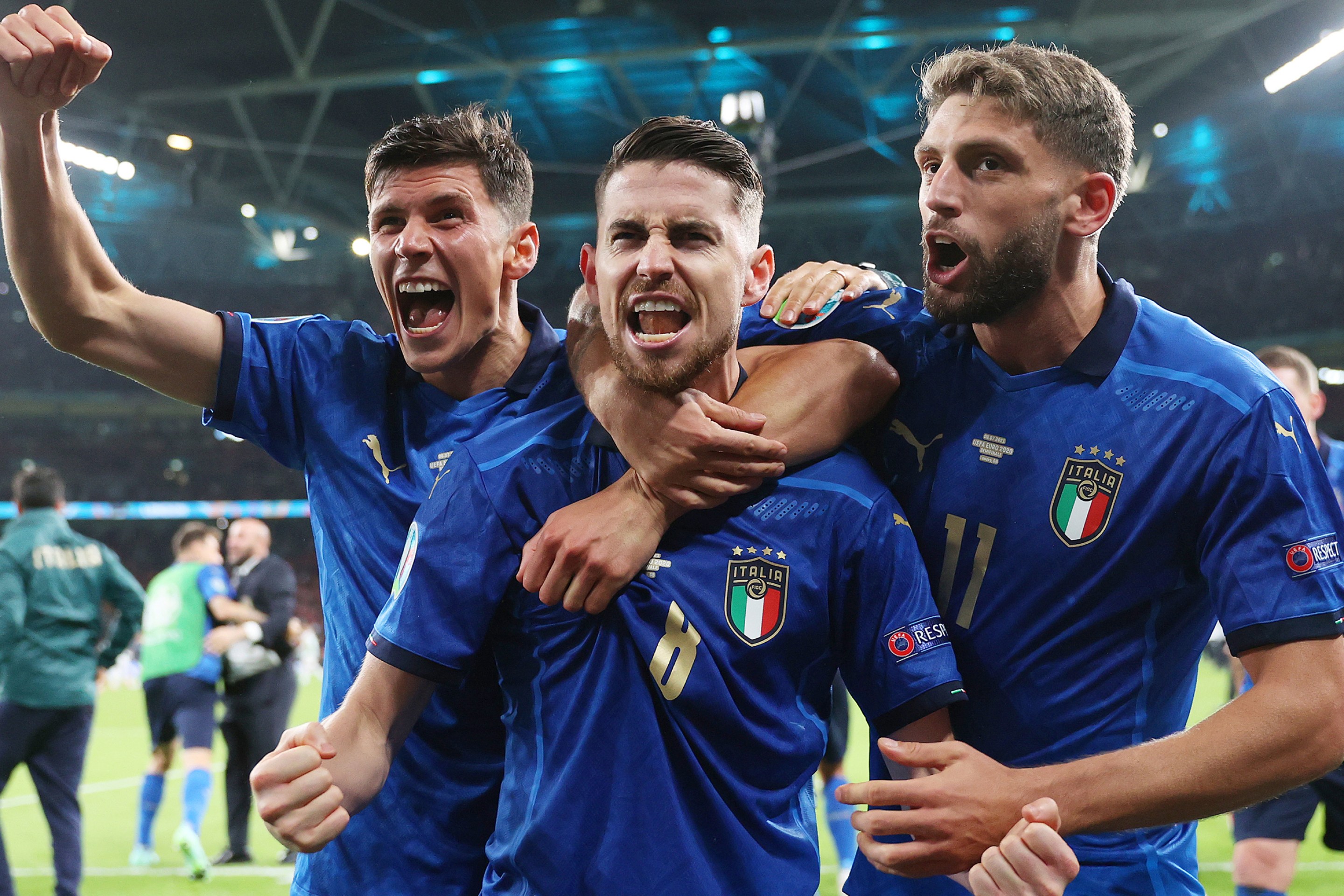 Jorginho of Italy celebrates with Matteo Pessina and Domenico Berardi after scoring their sides winning penalty in the penalty shoot out during the UEFA Euro 2020 Championship Semi-final match between Italy and Spain at Wembley Stadium on July 06, 2021 in London, England.
